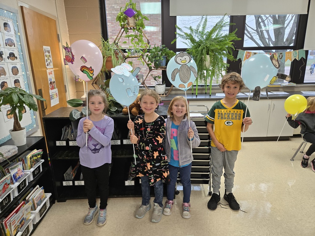 students holding balloon creations