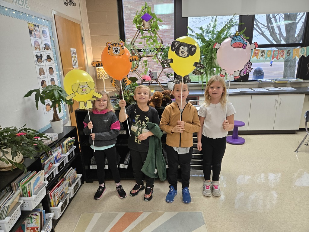 students holding balloon creations