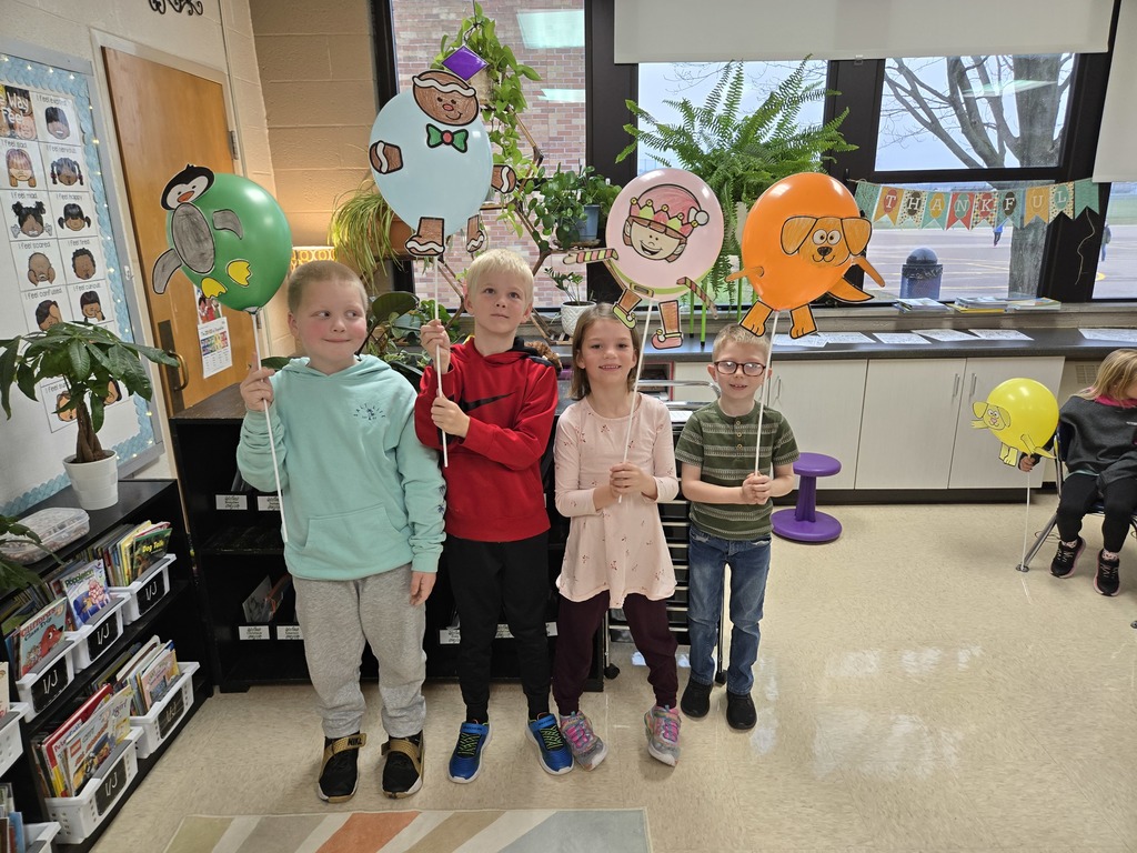 students holding balloon creations