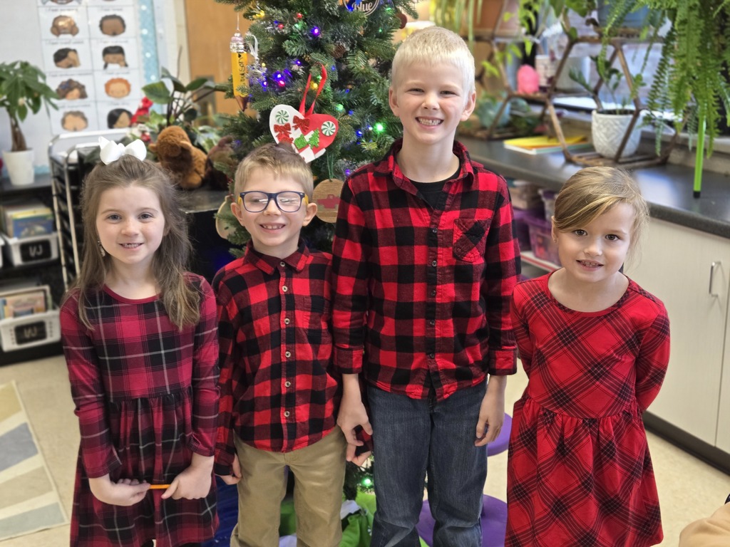 students in front of christmas tree