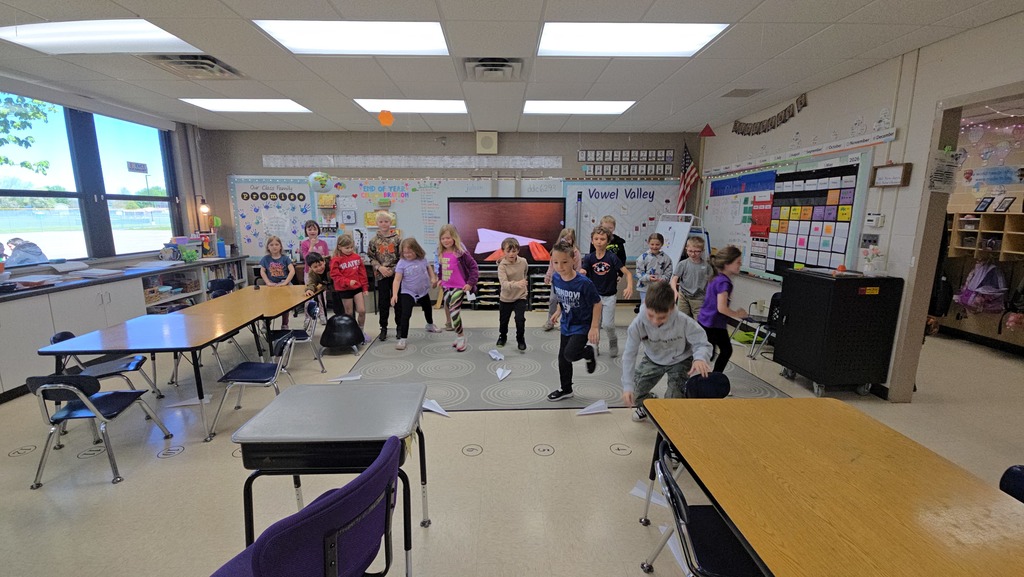 students throwing paper airplanes