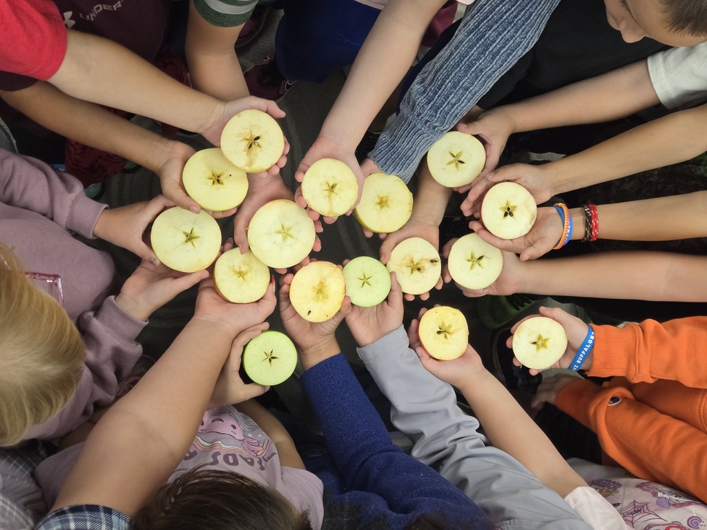 students holding an apple