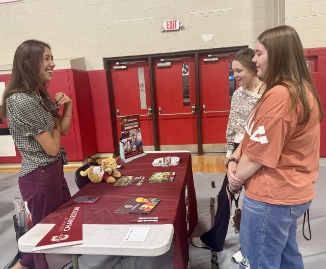 MCHS Students at the College of Charleston table talking to an admission rep. 