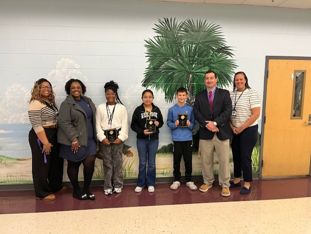 Pictured: Left to Right Mrs. Drayton-Asst. Principal, Ms. Brown-Asst. Principal, Kennedi Jones-6th Grade Student of the Month, Maite Gonzalez Martinez-7th Grade Student of the Month, Maddox Harvey-8th Grade Student of the Month, Mr. Reid-Principal, & Dr. Jeter-Asst. Principal