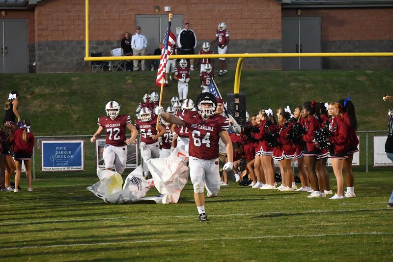 Rebels Team Running onto the field for the 2026 Homecoming Game