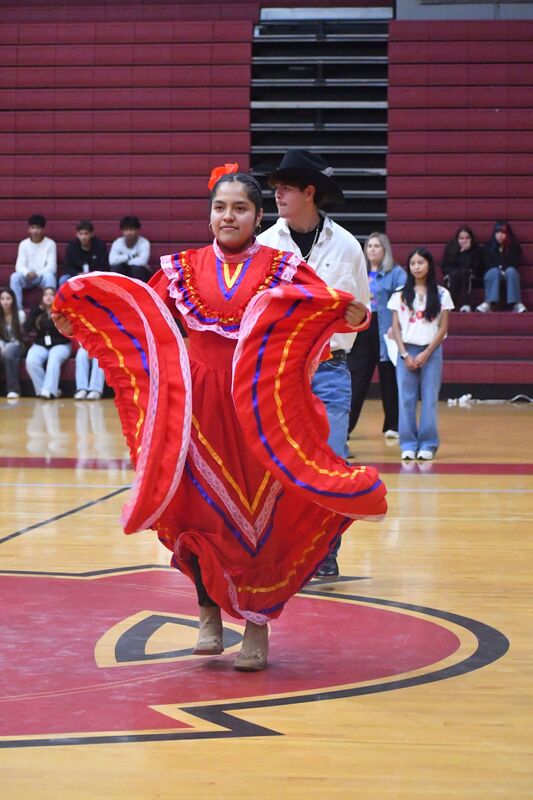 Student dancing a traditional Hispanic dance with a flowing skirt