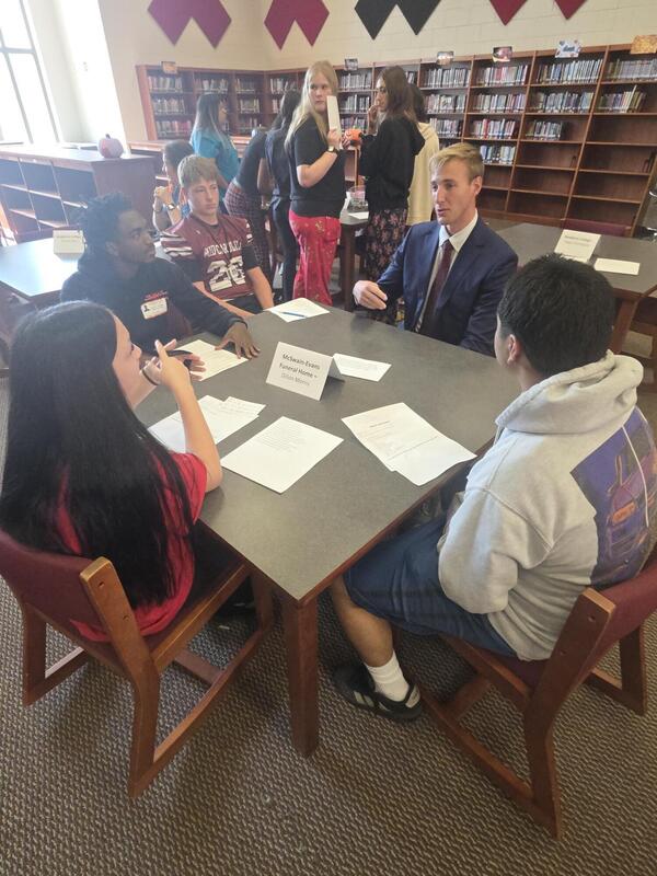 Students talking to a career professional about their career path at the Fall 2026 Human Library