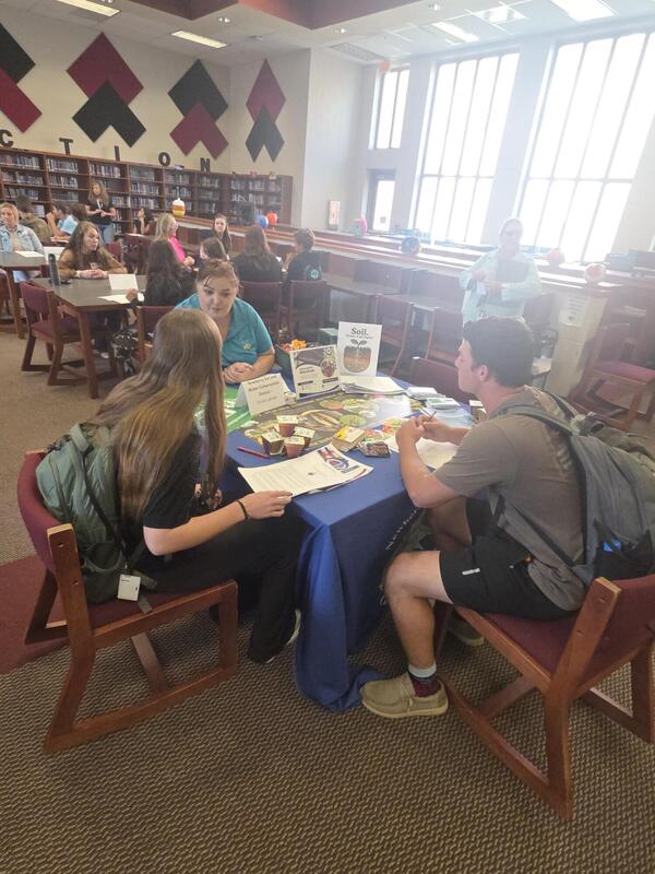 Students talking to a career professional about their career path at the Fall 2026 Human Library