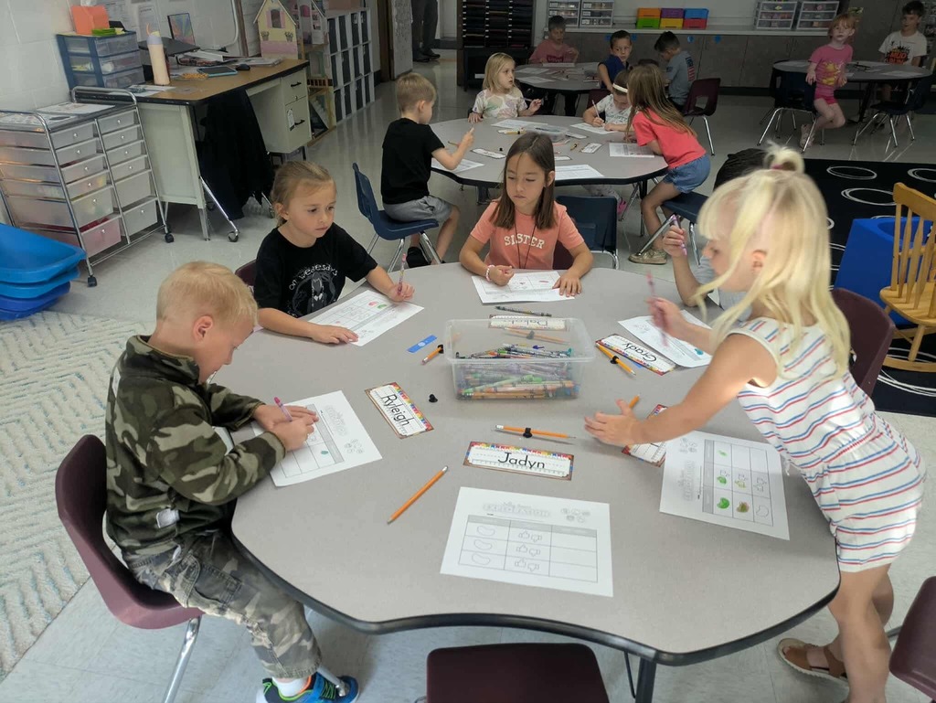 Young learners working together around a table.
