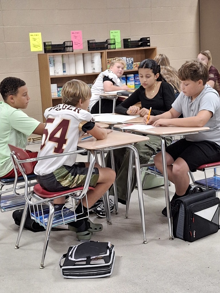 Teams of middle school students working collaboratively.