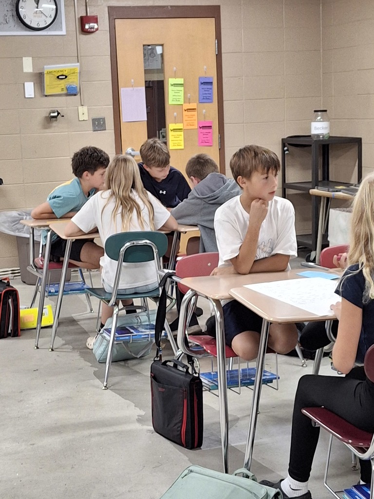 Teams of middle school students working collaboratively.