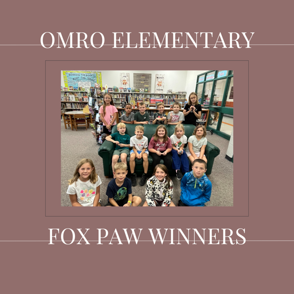 A group of elementary students gathered in a media center.
