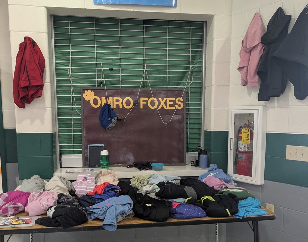 A picture of a table with lost and found items on it.