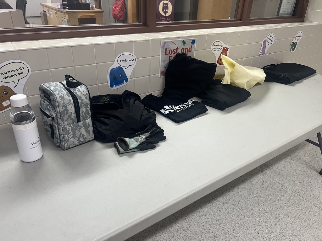 A picture of a table with lost and found items on it.