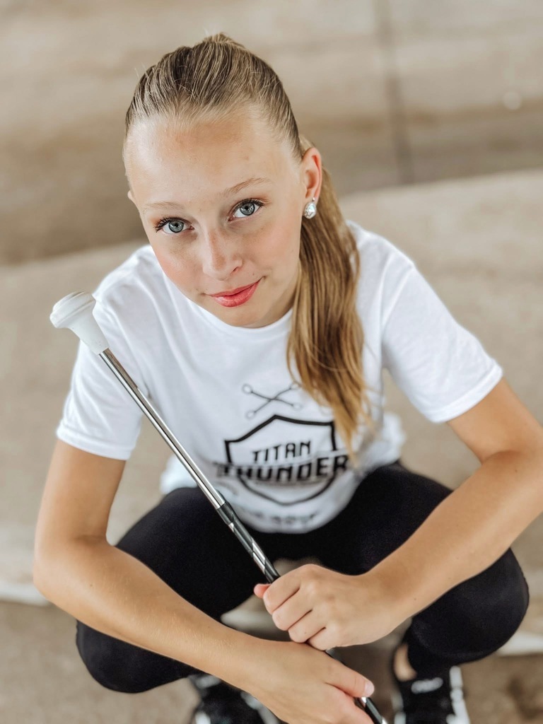 Middle school girl posing with her baton