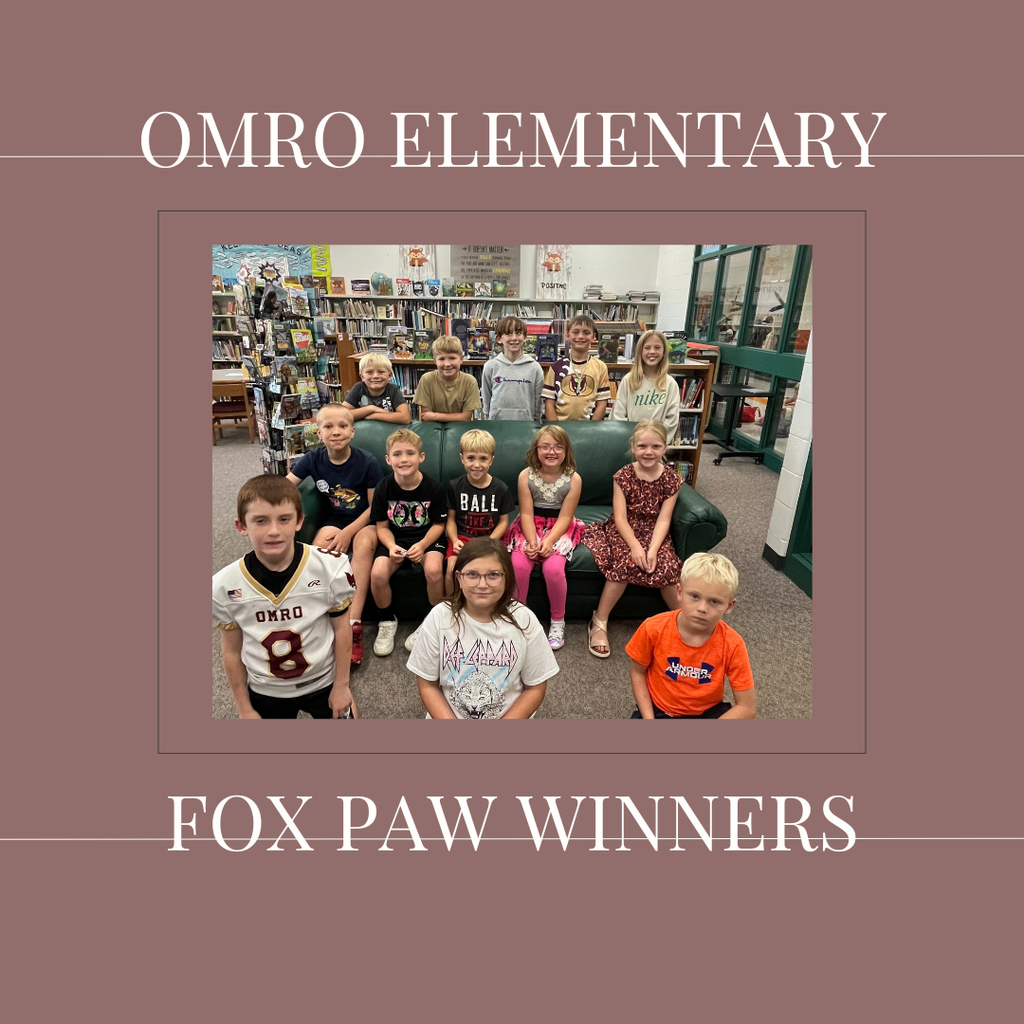 A group of elementary students standing in a media center.