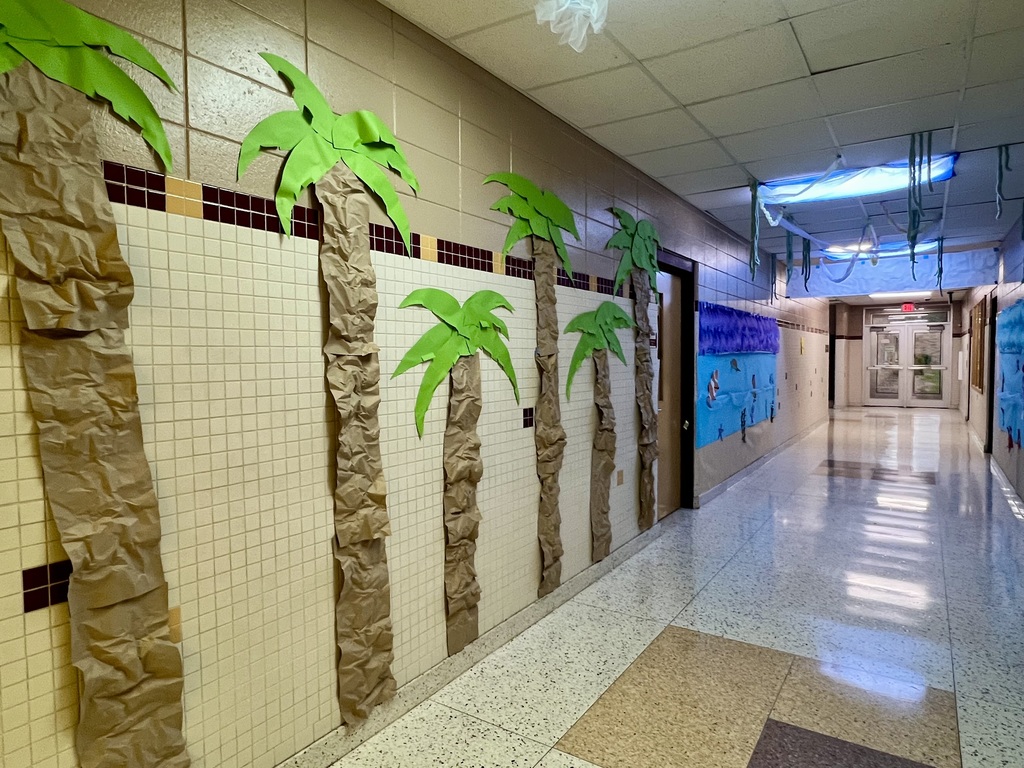 Hallway decorated with paper palm trees.