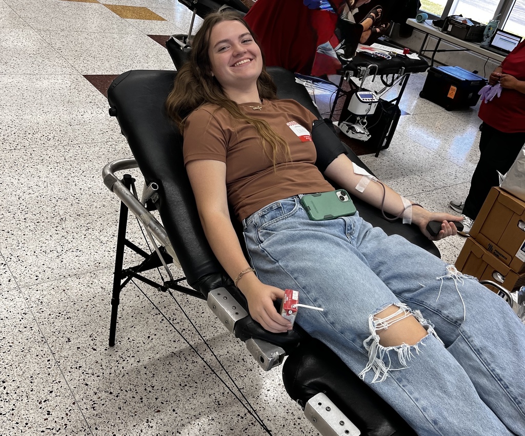 High school student giving blood