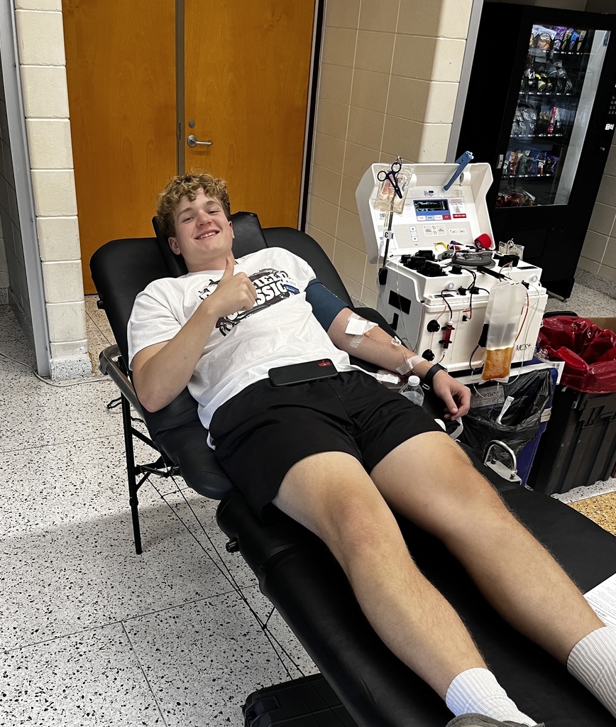 High school student giving blood