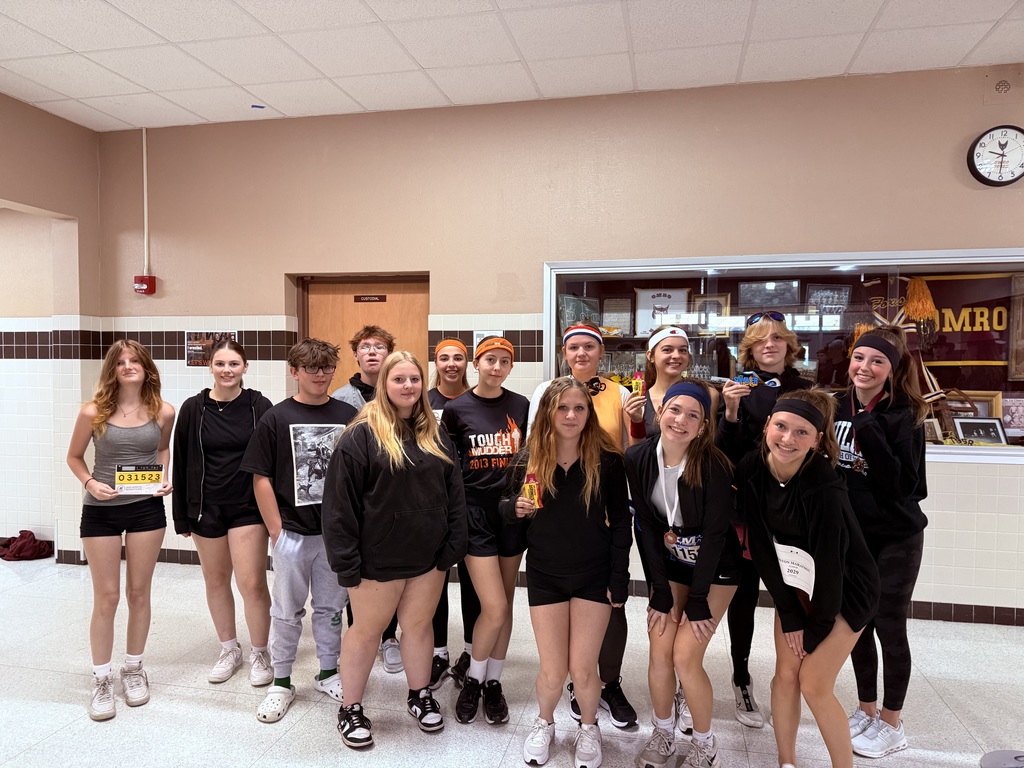 High school students, dressed in black clothes, stand together for a photo.