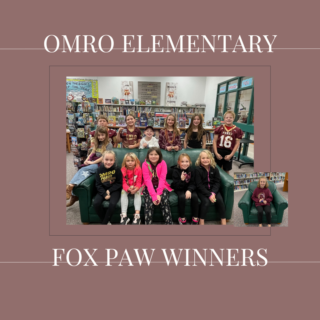 A group of elementary students standing in a media center.