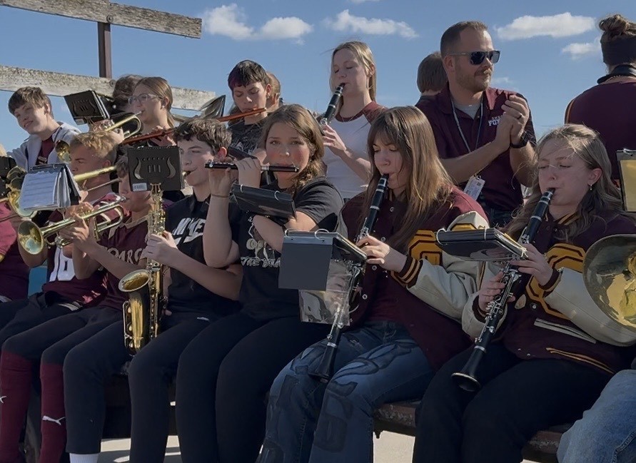 High school students on a float playing instruments for the band.
