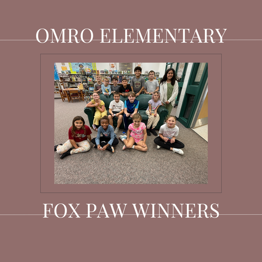 A group of elementary students standing in a media center.