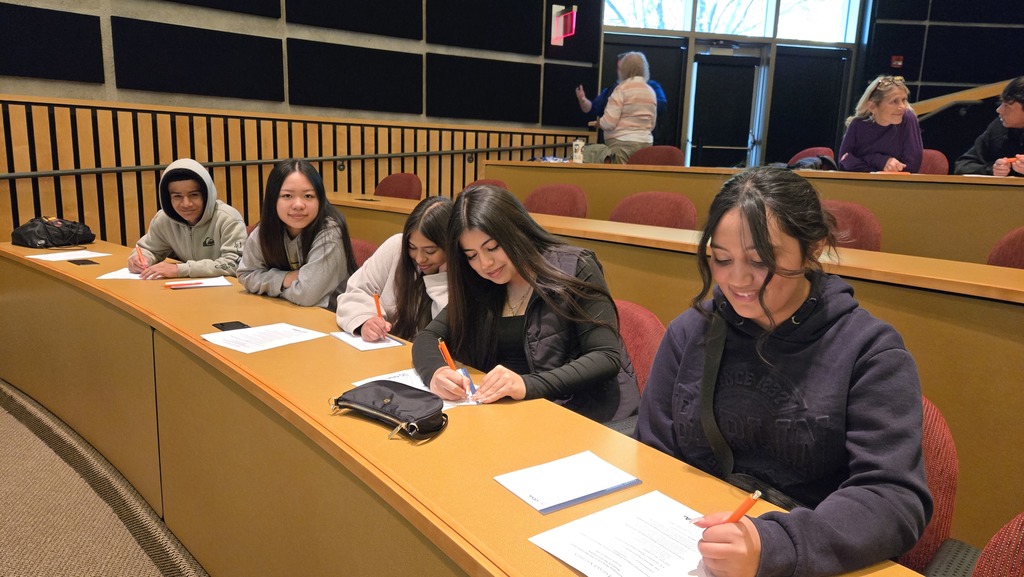 High school students sitting in a lecture hall. 