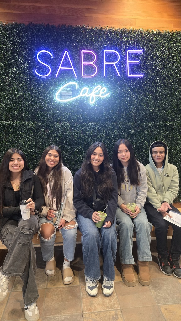 5 high school students sitting together.
