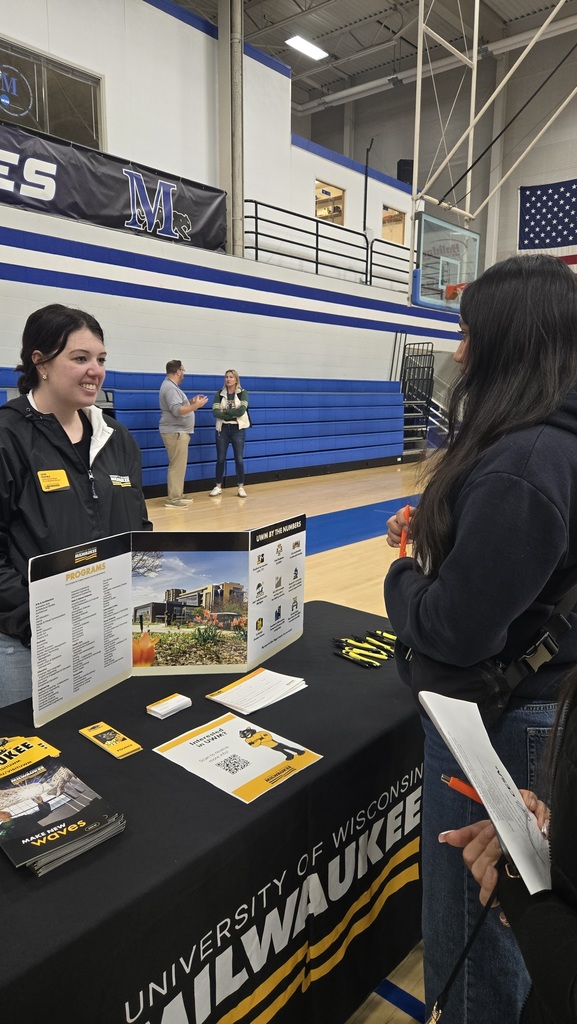 A high school student talking to a representative from UW Milwaukee.