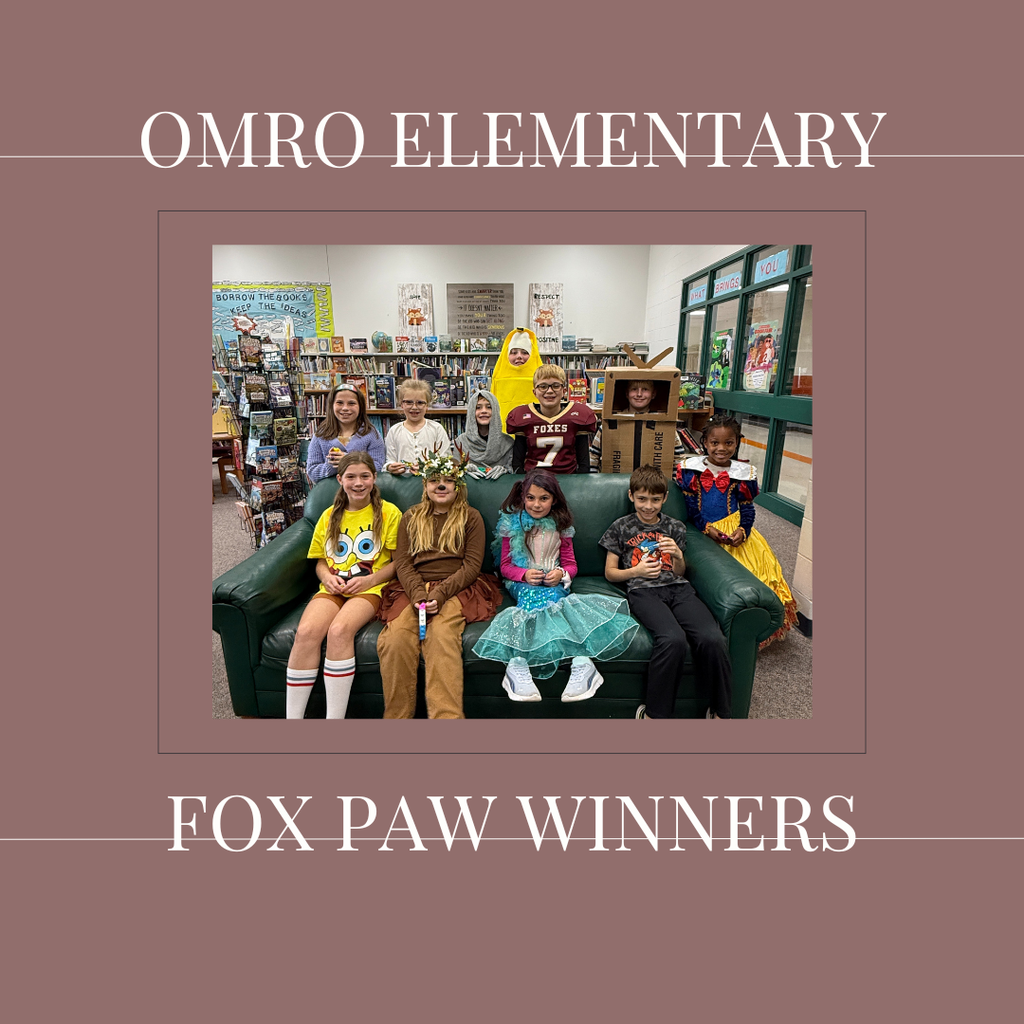 A group of elementary students standing in a media center.