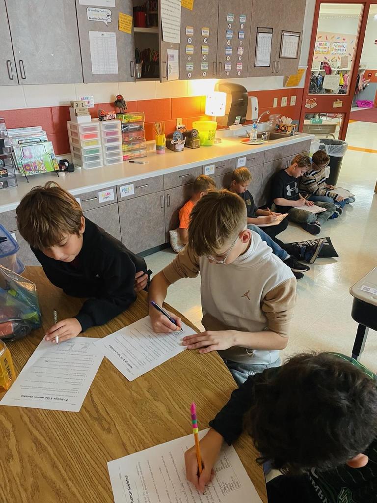 Elementary students working together to complete a learning activity. 