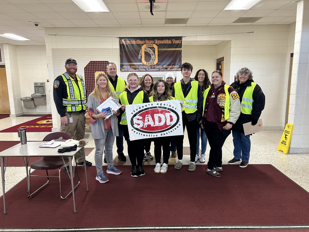 Staff and students wearing safety vests.
