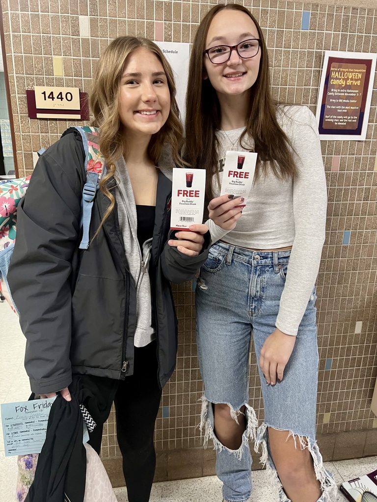 Two students holding their Free Drink coupon for wearing a seat belt this morning.