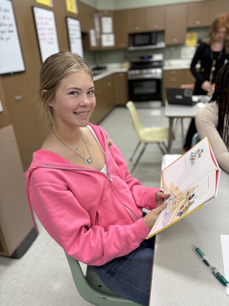 High school student practices reading a book out loud.