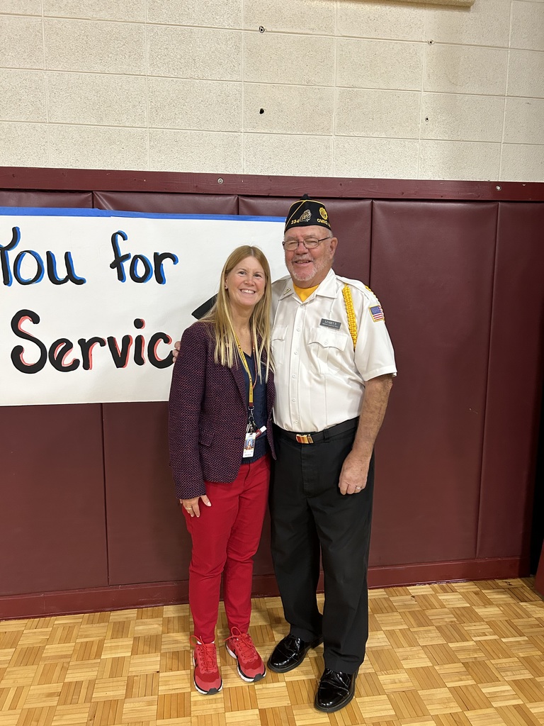 A teacher and veteran standing together.