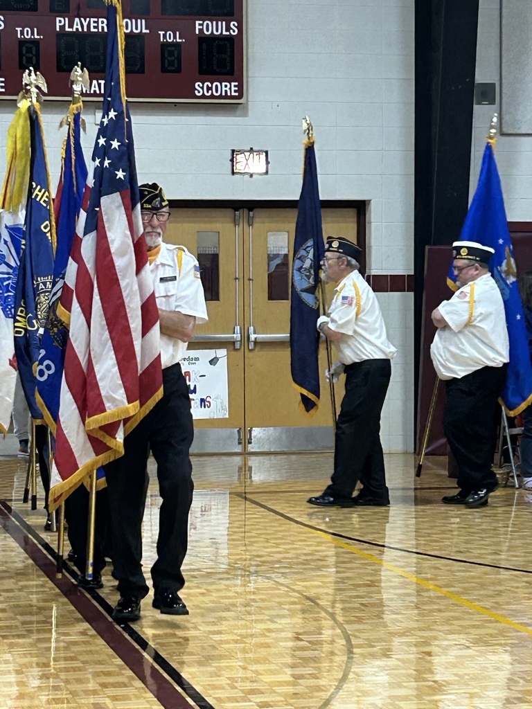 Veterans walking in with flags.