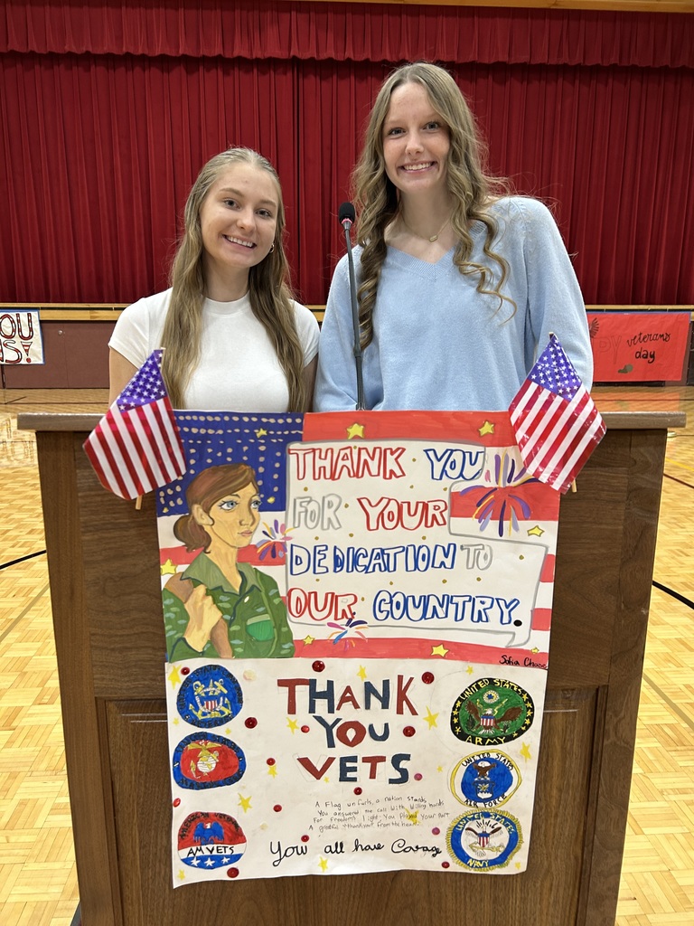 Two high school students standing at a podium.