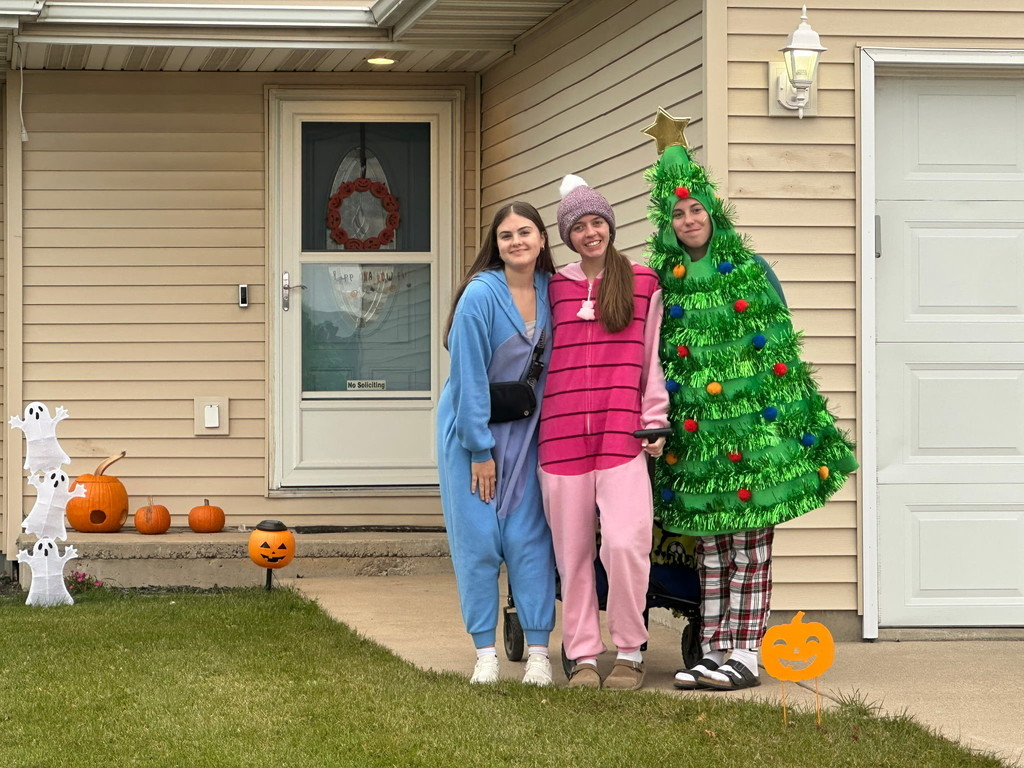 High school students trick or treating for canned goods.