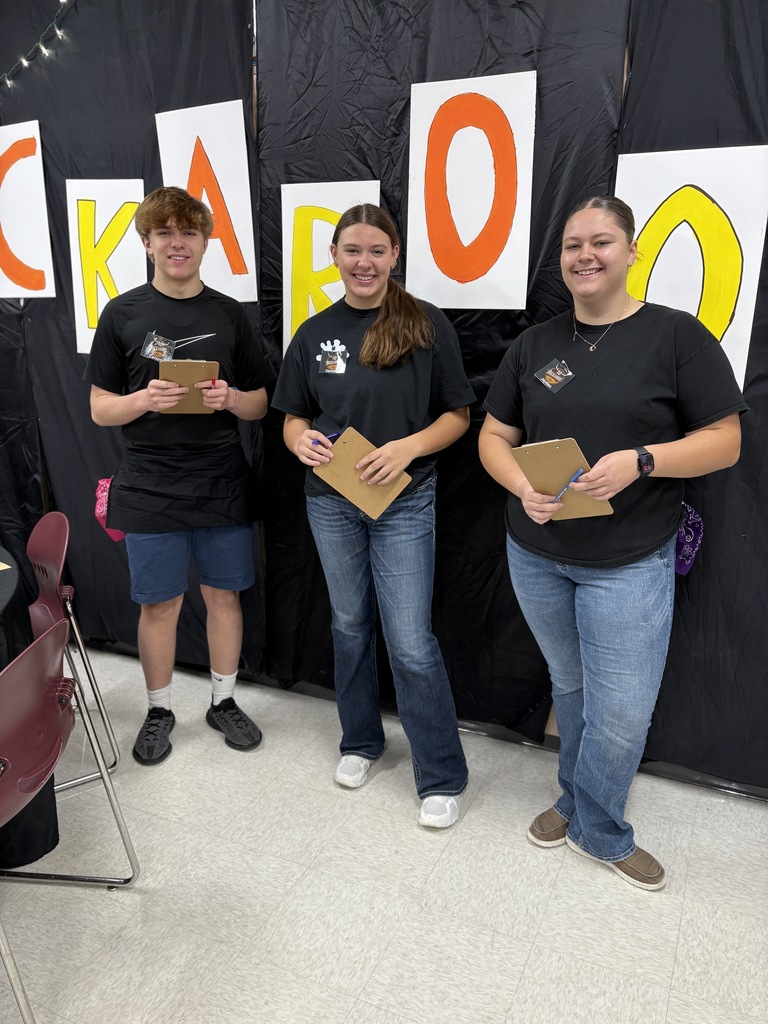 3 high school students standing together. 