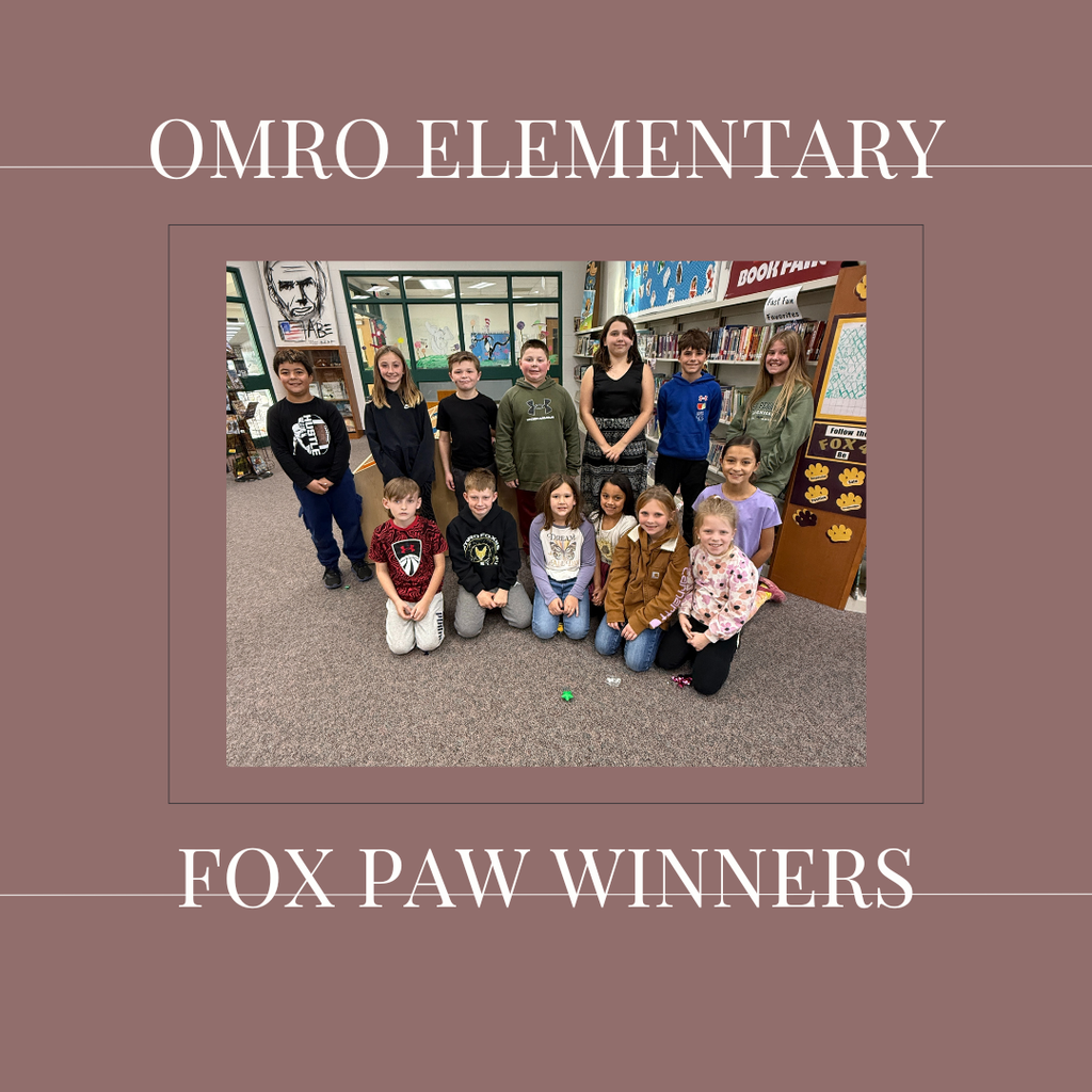 A group of elementary students standing in a media center.
