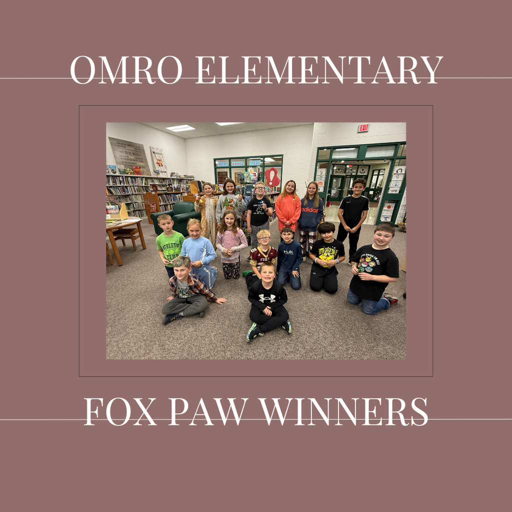 A group of elementary students gathered in a media center.