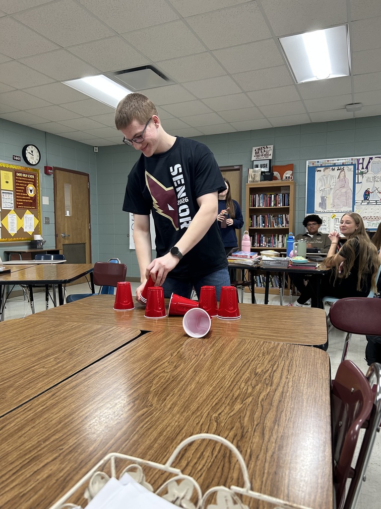 High school student cup stacking with plastic cups. 