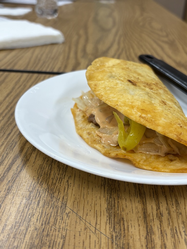 Picture of a burger in a taco shell.