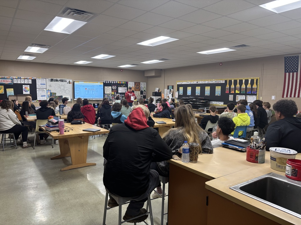 A photographer speaking to a high school class.