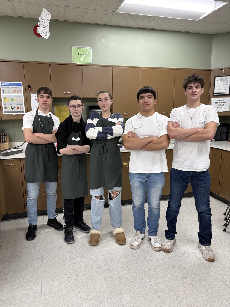 A group of five high school s tudents standing together.