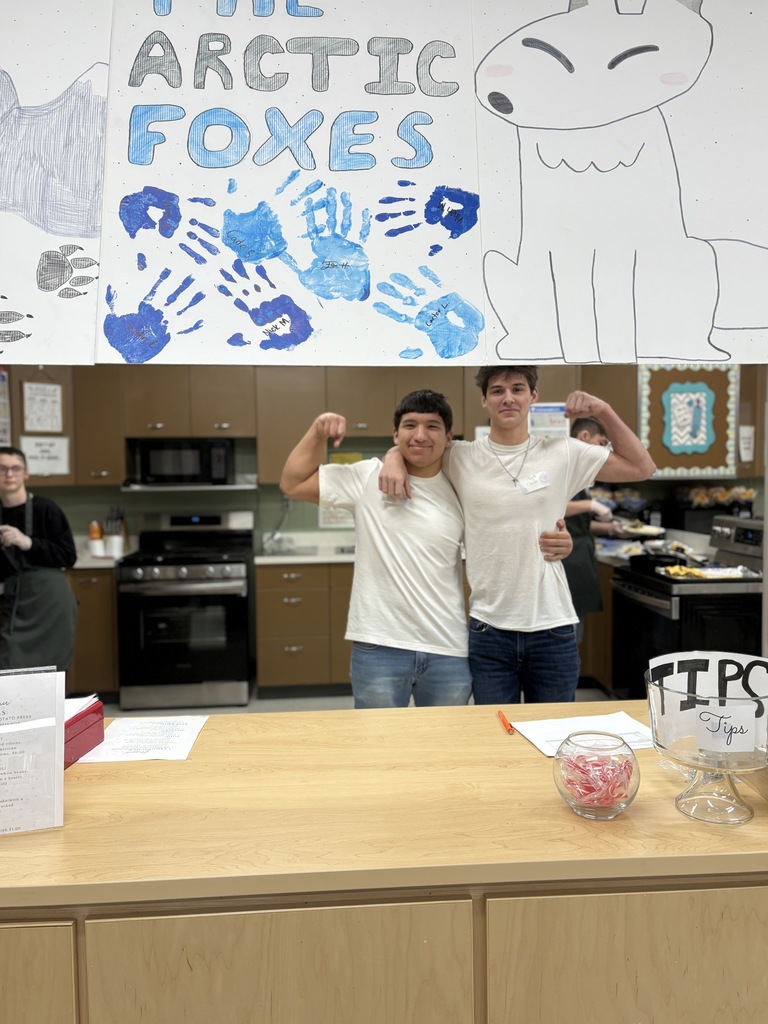 Two high school students posing together.
