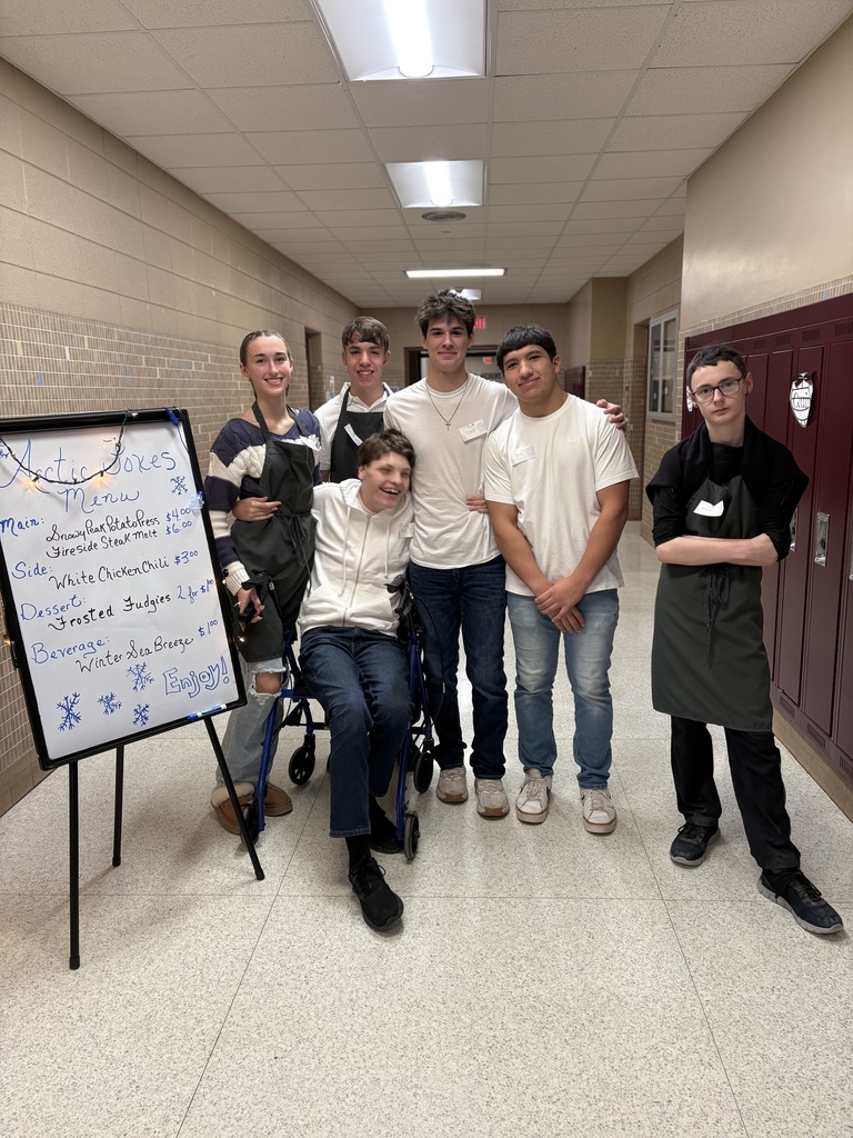 High school students standing together in the hall. 