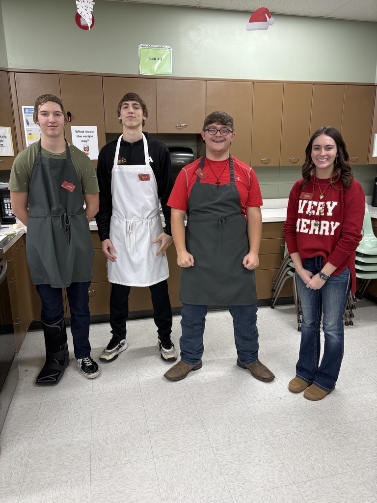 Four high school students standing next to one another.