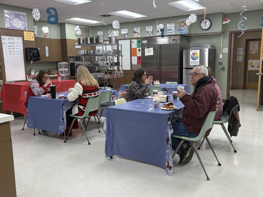 Staff enjoying food prepared by high school students.